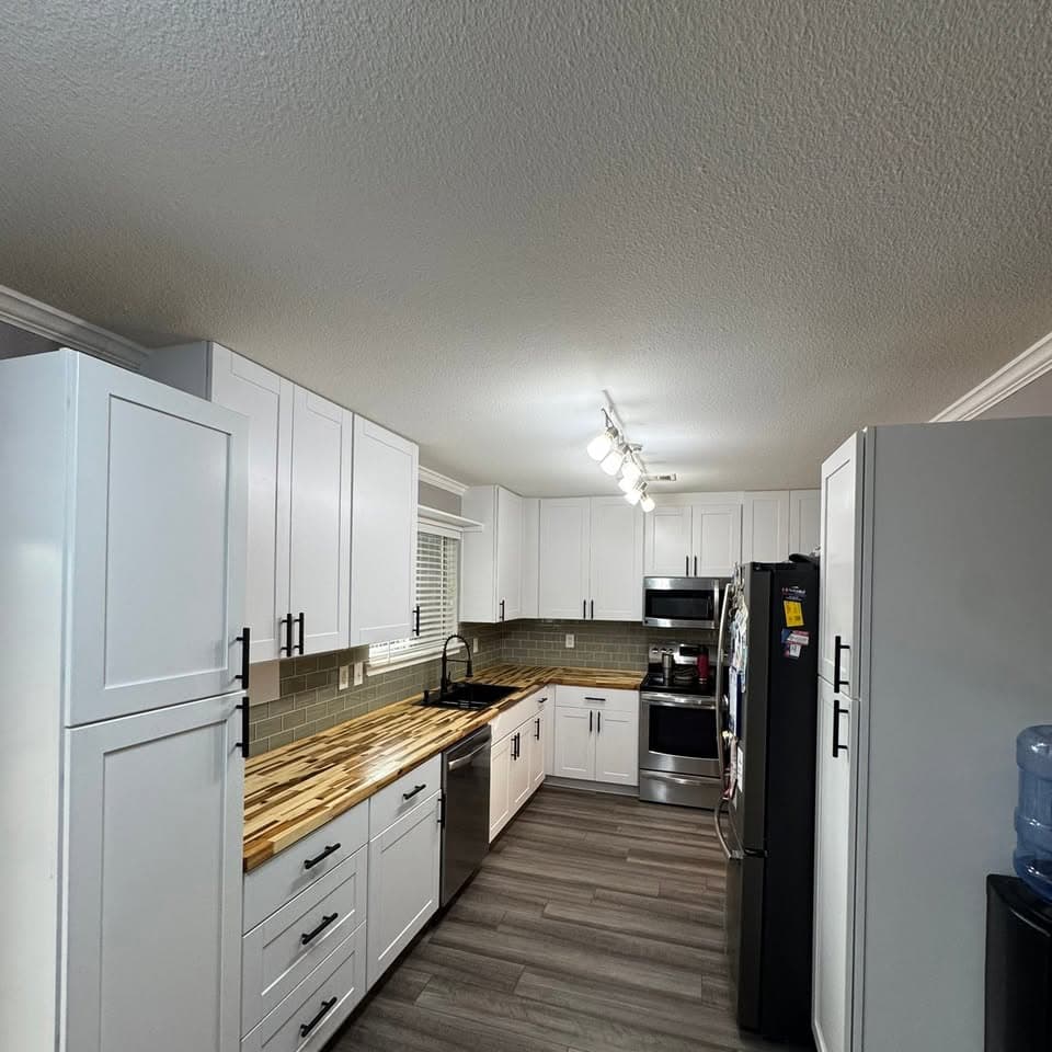 Finished kitchen with white cabinetry and updated flooring